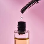 Cosmetic oil for the growth of eyebrows and eyelashes with a brush.